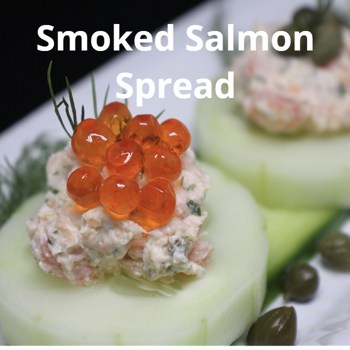 Elegant cucumber rounds topped with a creamy smoked salmon spread made from cream cheese, chopped smoked salmon, lemon juice, dill, chives, and capers, garnished with salmon roe, capers, and dill.