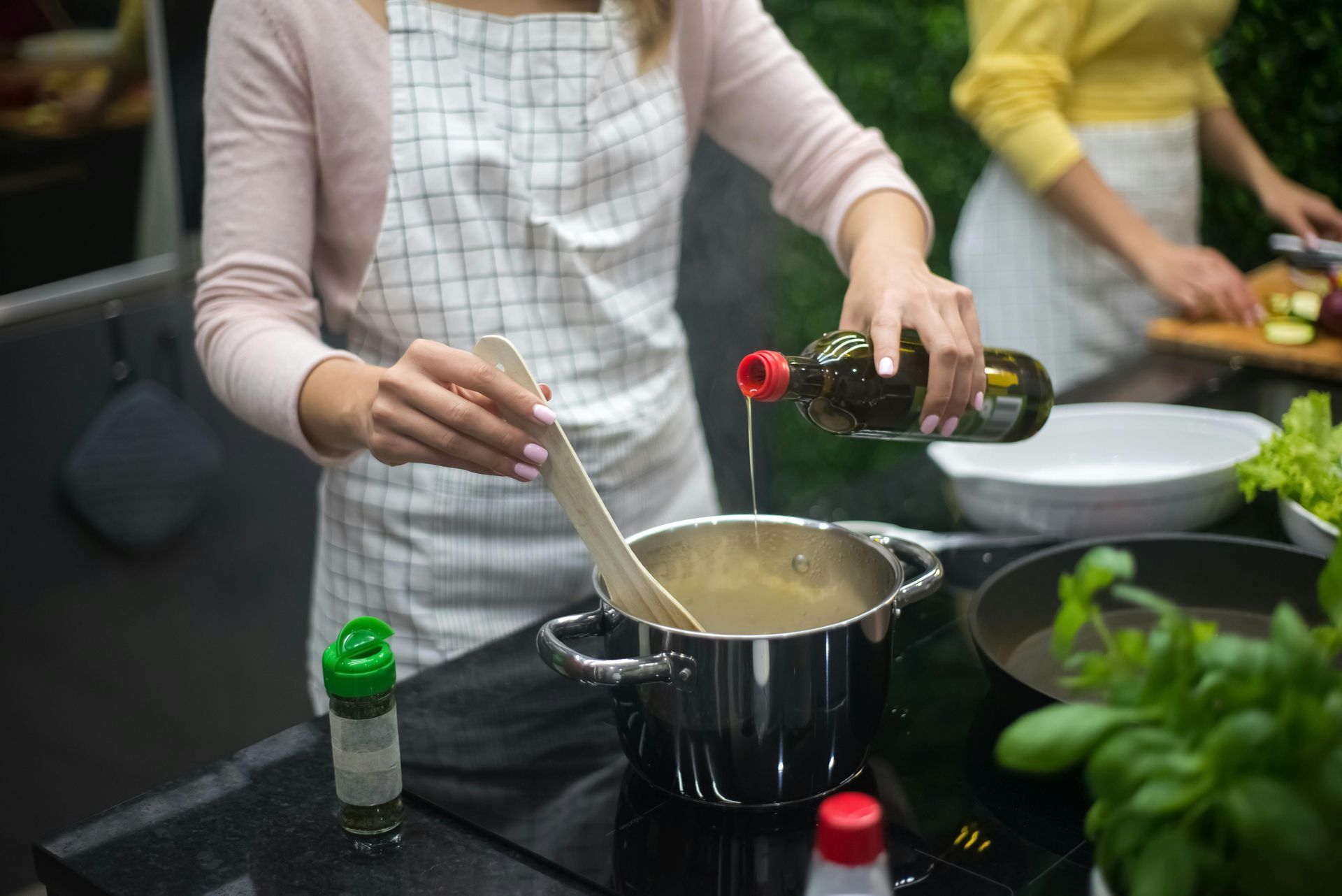 A person in a cozy kitchen preparing delicious meals, with fresh ingredients, kitchen utensils, and recipe books spread out on the counter, capturing the warmth and joy of home cooking.
