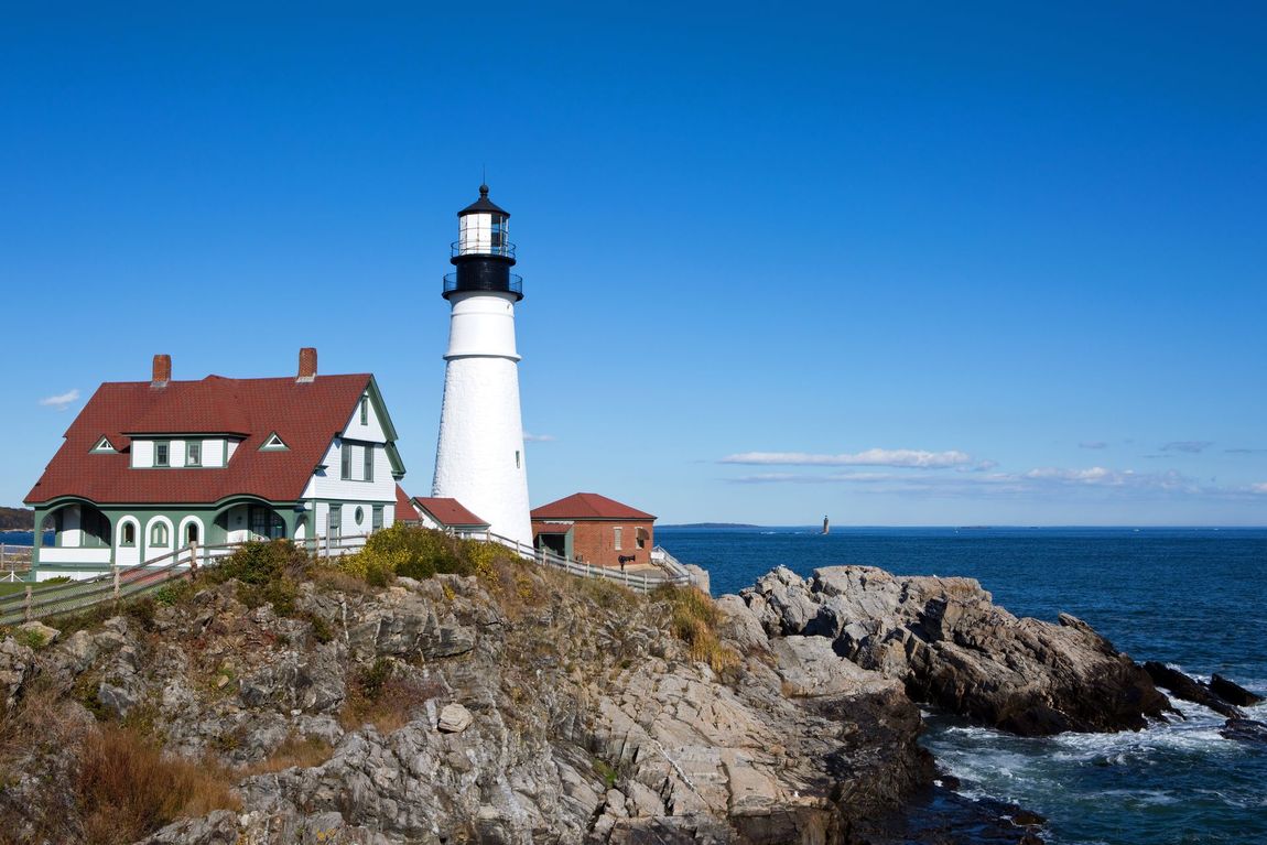 Portland Head Light lighthouse on rocky cliff along the ocean. Cape Elizabeth, Maine.
