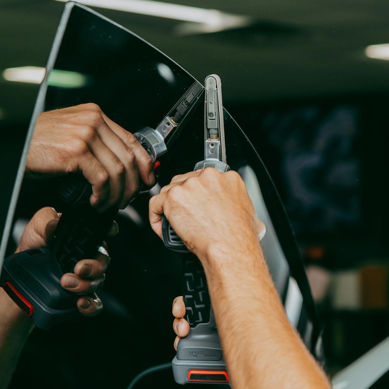 A person is holding a tool that has the letter k on it