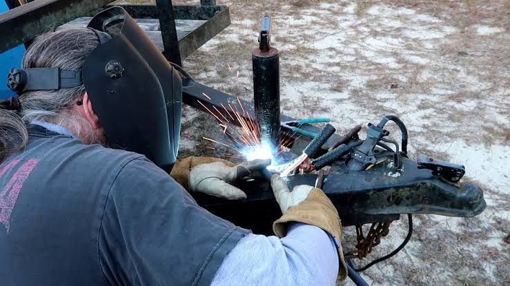 A Trailer Is Sitting On The Ground Next To A Car — Bohle Welding & Trailer Repairs In Bohle, QLD