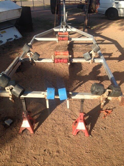 A Boat Trailer Is Sitting Next To A Car — Bohle Welding & Trailer Repairs In Bohle, QLD