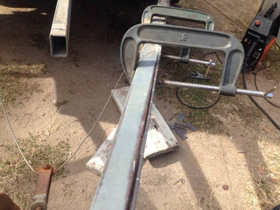 A Piece Of Metal Is Being Clamped — Bohle Welding & Trailer Repairs In Bohle, QLD