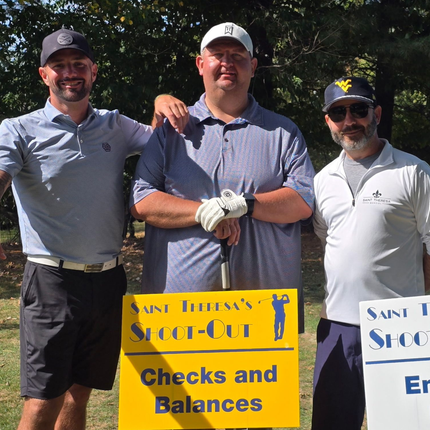 Three people in golf attire pose behind a