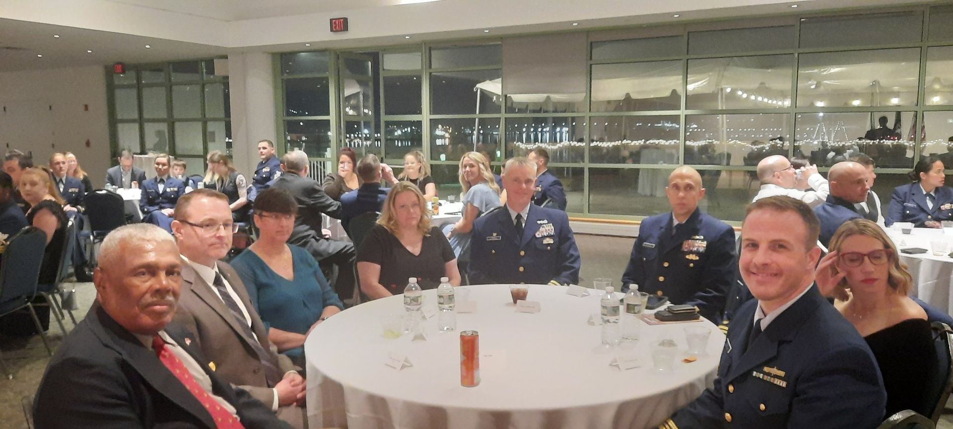 A group of people are sitting around a table in a room.