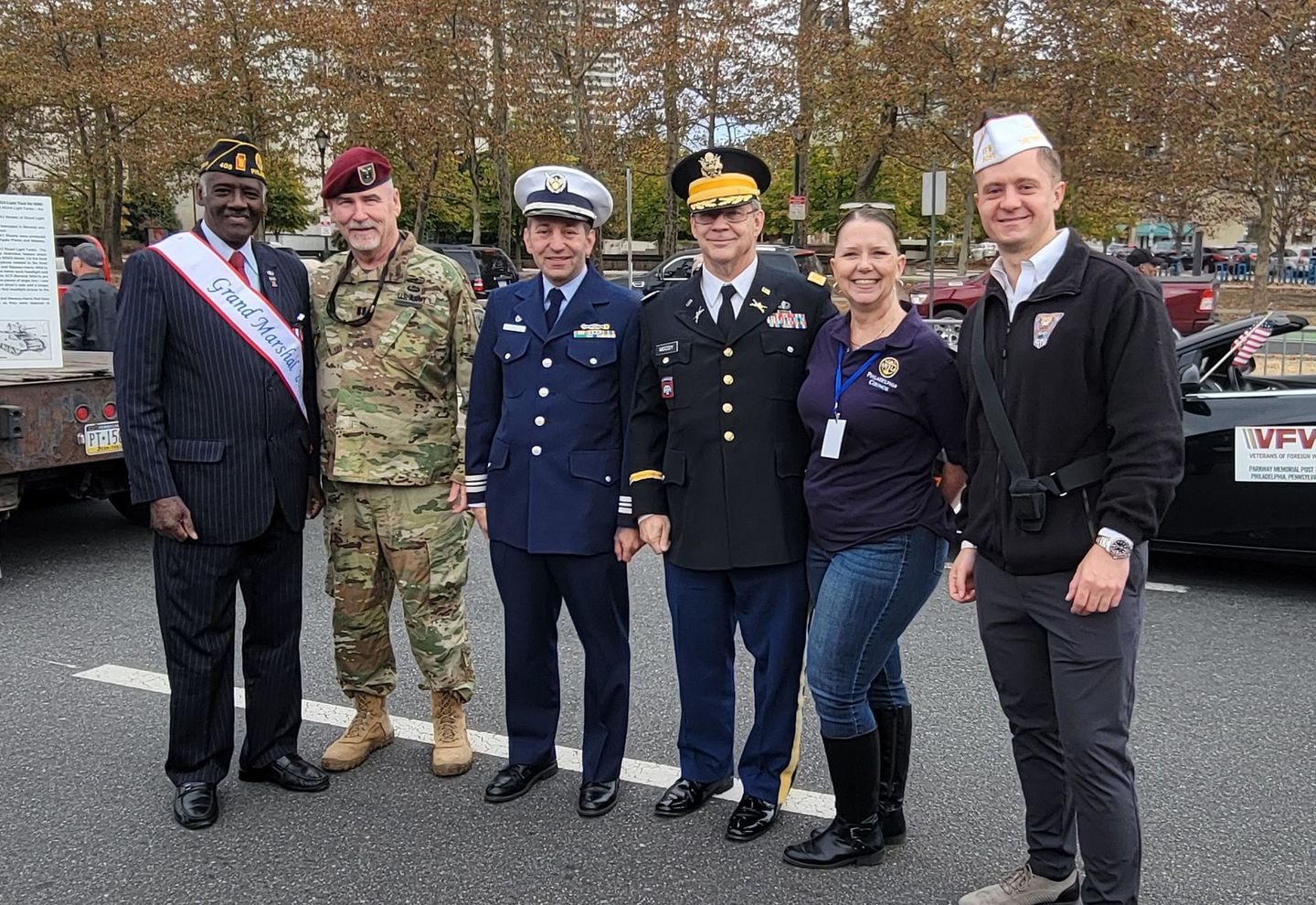 A group of people in military uniforms are posing for a picture