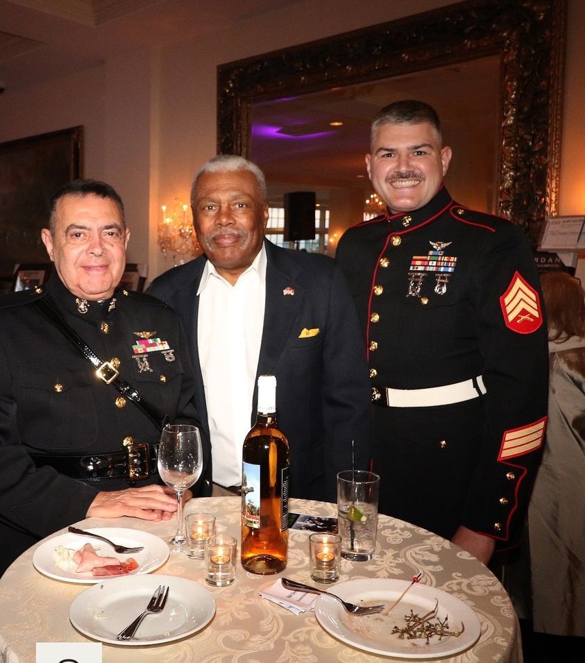 Three men in military uniforms are posing for a picture