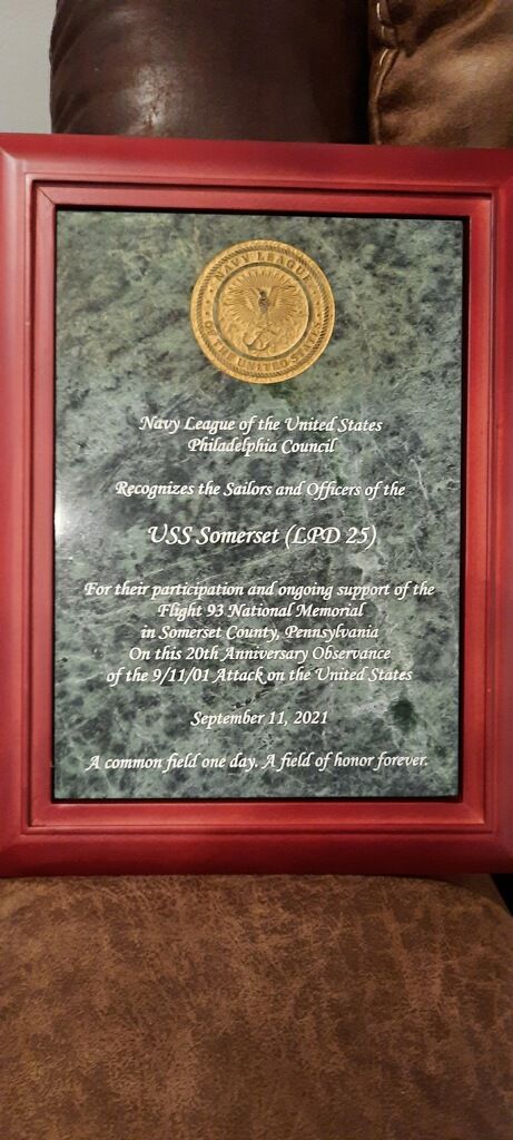 A Plaque in A Red Frame Is Sitting on A Couch