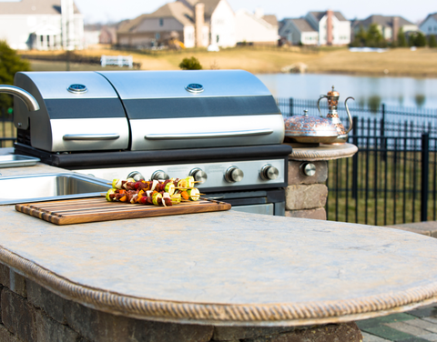 Outdoor Grill and grill table with pond in background