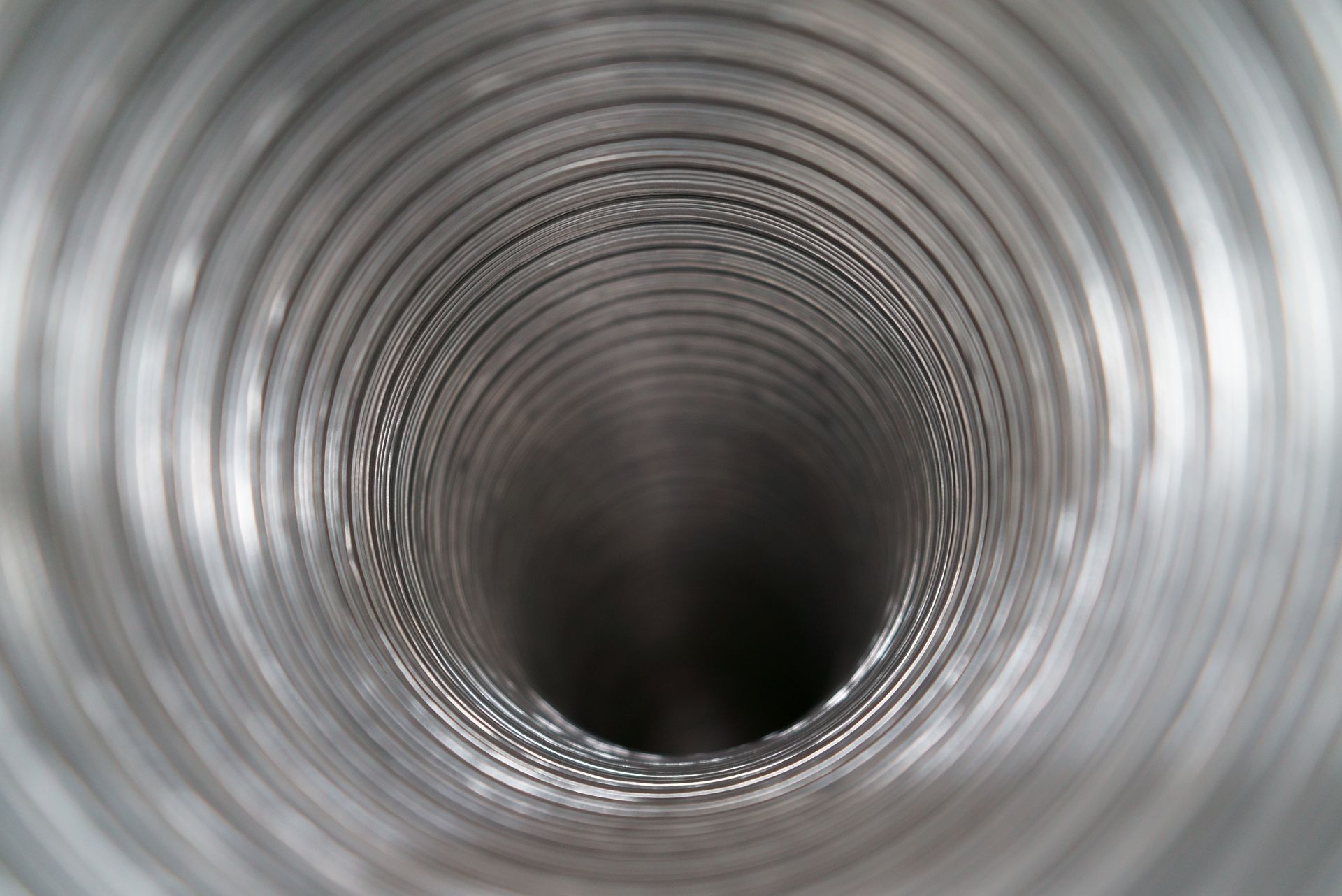 Inside view of a metallic, flexible duct with spiraling ridges. Inside view of a metallic, flexible duct with spiraling ridges.