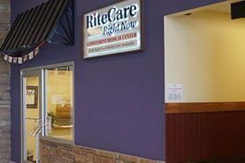 RiteCare sign above a storefront entrance with a purple exterior wall and lit interior hallway