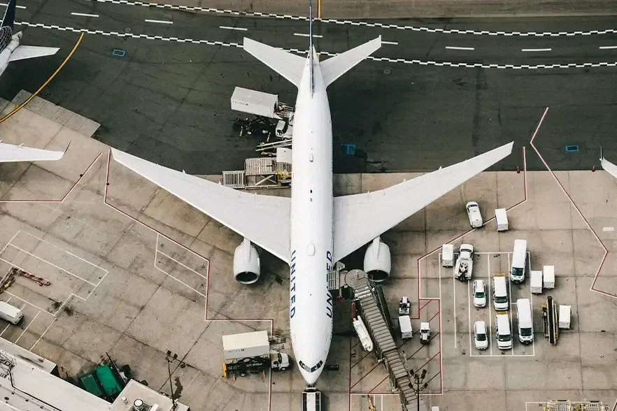White and blue airplane on airport during daytime