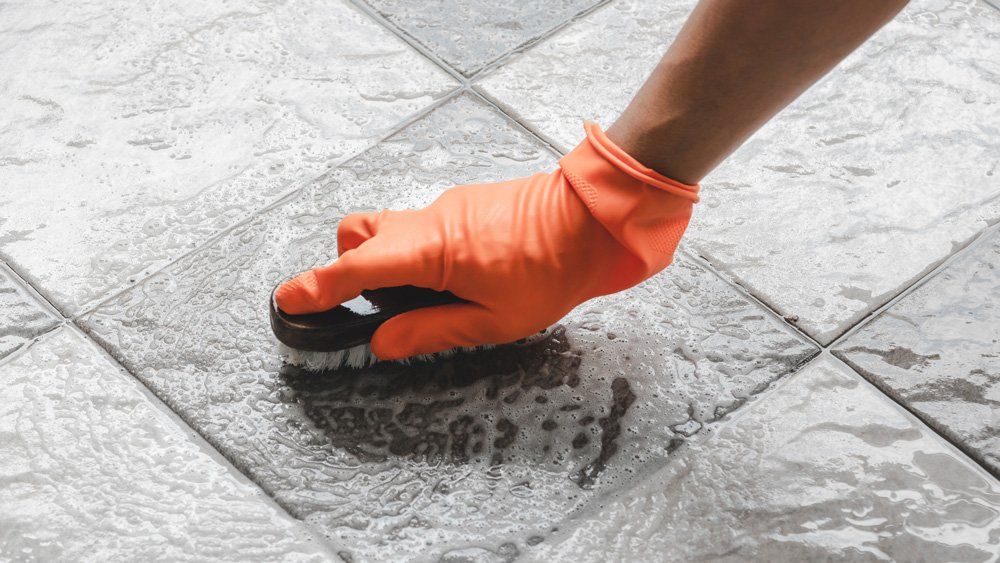 Brushing Tile — Valley, NY — Classic Carpet and Upholstery Cleaning Vacuuming The Sofa — Valley, NY — Classic Carpet and Upholstery Cleaning
