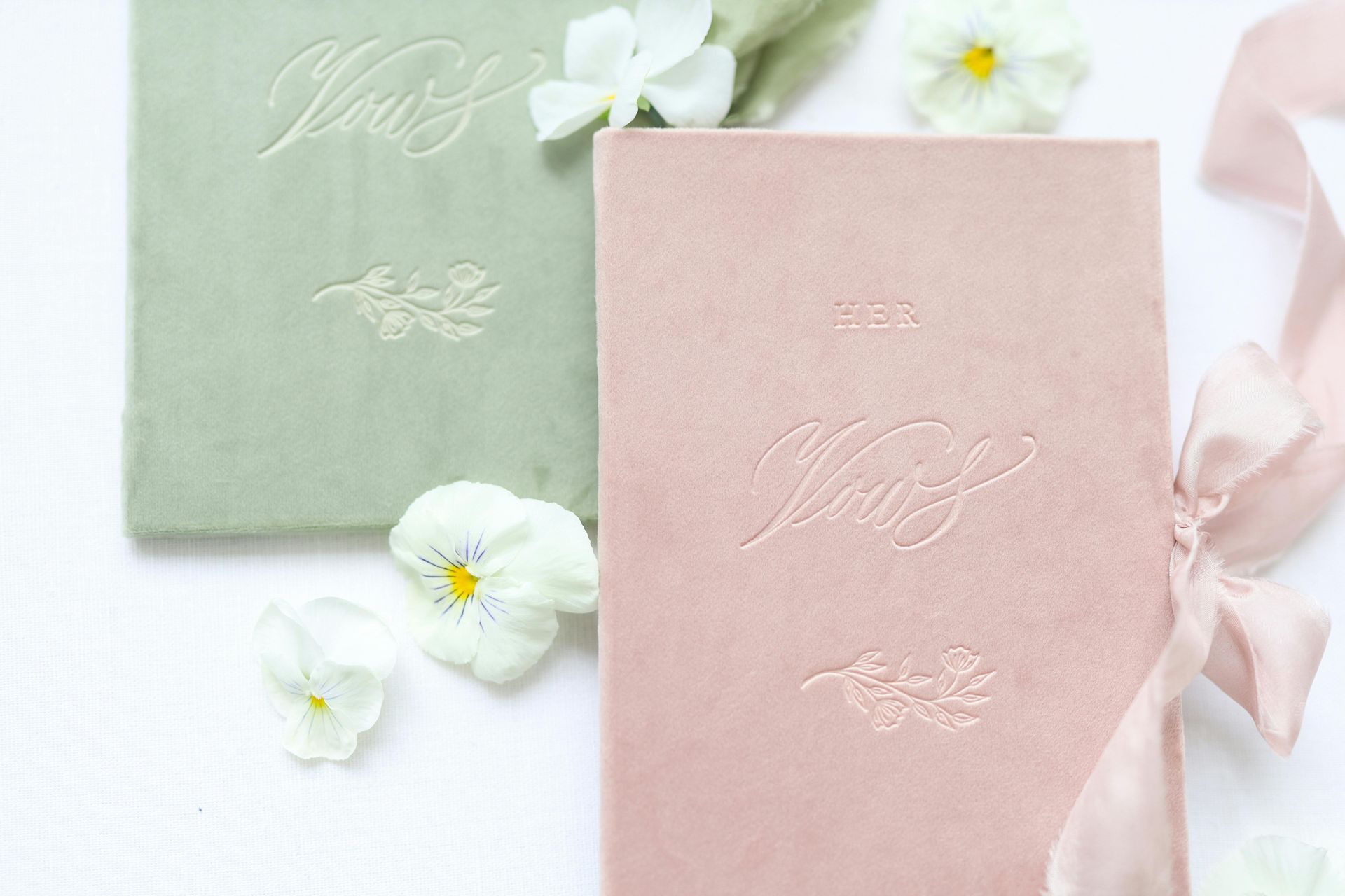 A black book with the word her on it is surrounded by flowers