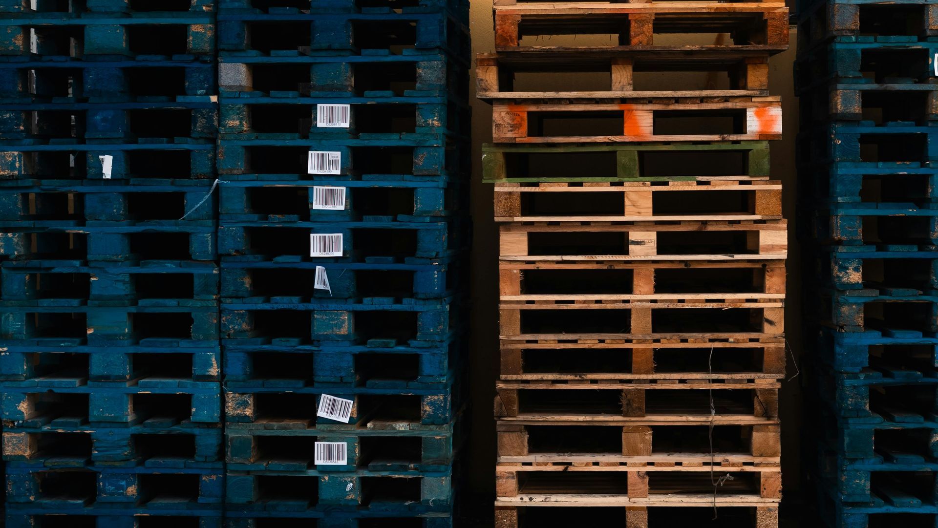 Stacks of blue and brown wooden pallets.