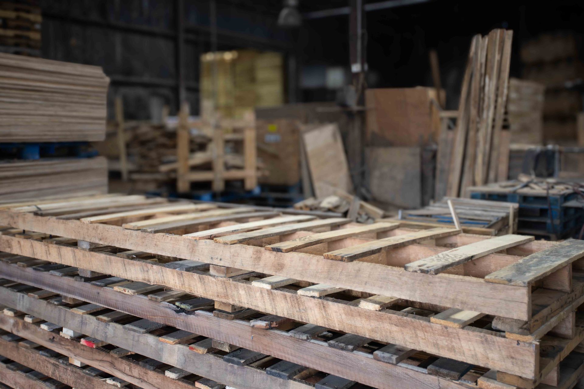 A warehouse filled with lots of wooden boxes and pallets