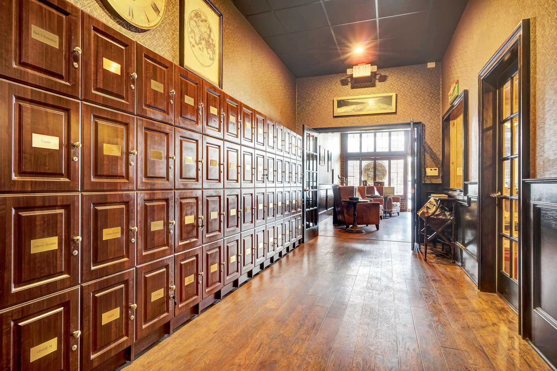 A long hallway filled with lots of wooden lockers