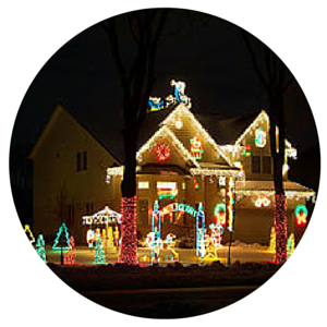 House covered in colorful Christmas lights and decorations at night