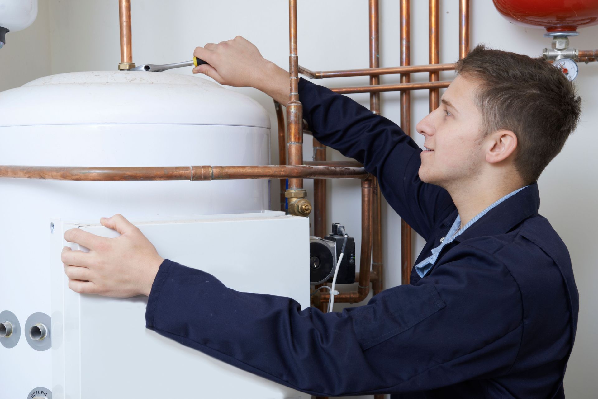 Plumber inspecting pipes during no call out fee service Brisbane