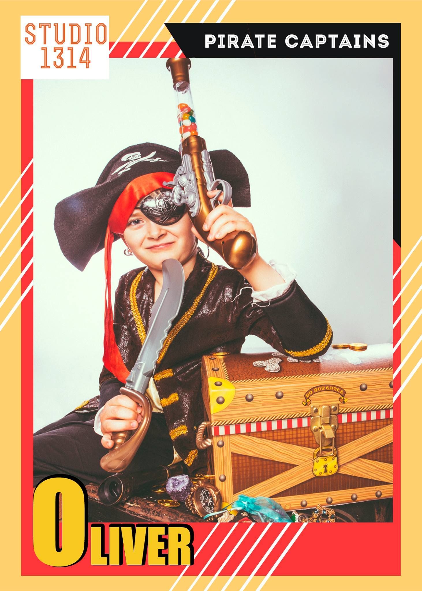 Boy dressed as a pirate with a sword and treasure chest