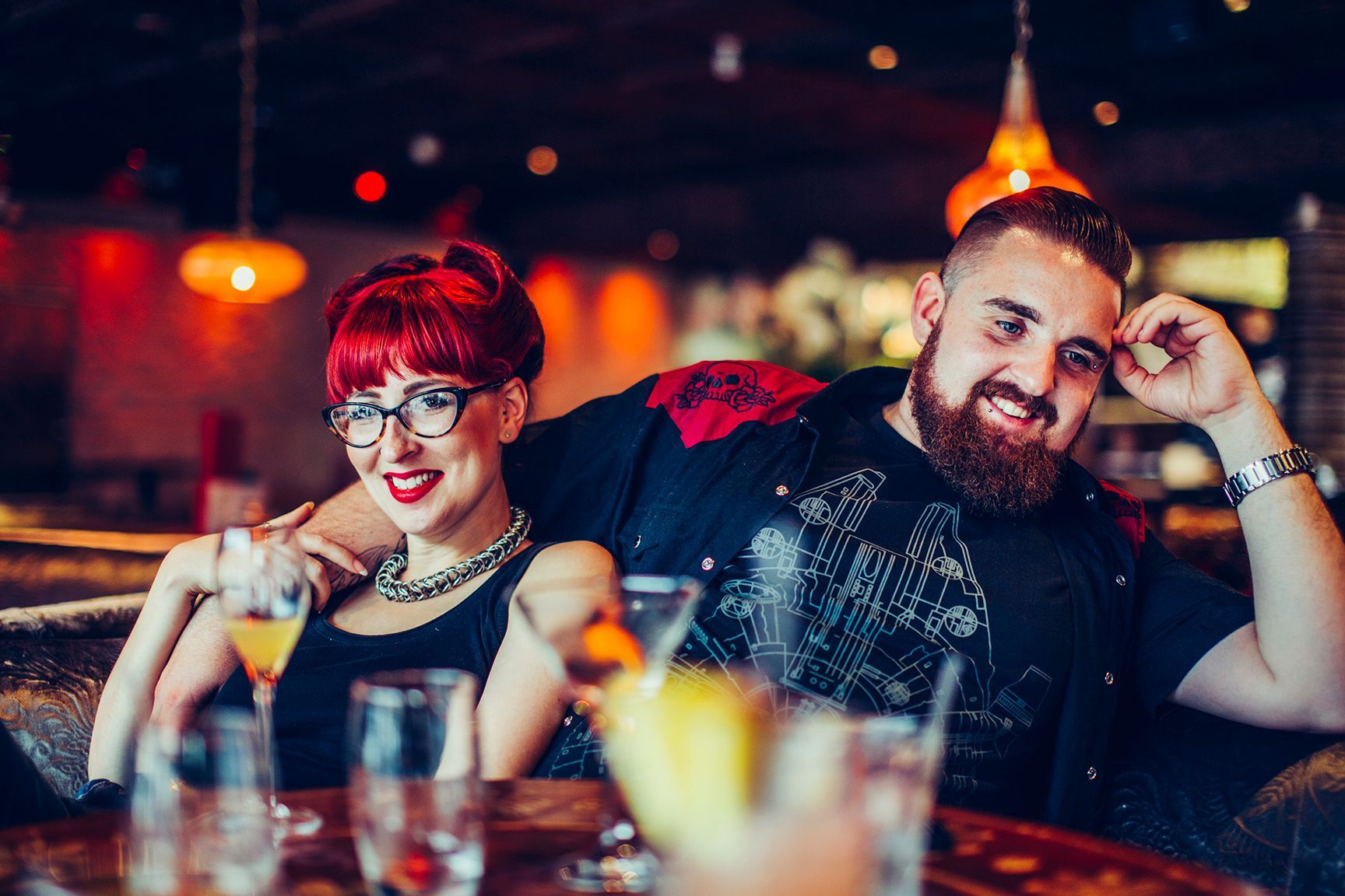A man and a woman are sitting at a table in a restaurant.