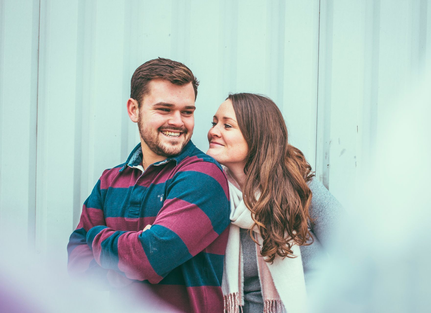 A man and a woman are standing next to each other and smiling.
