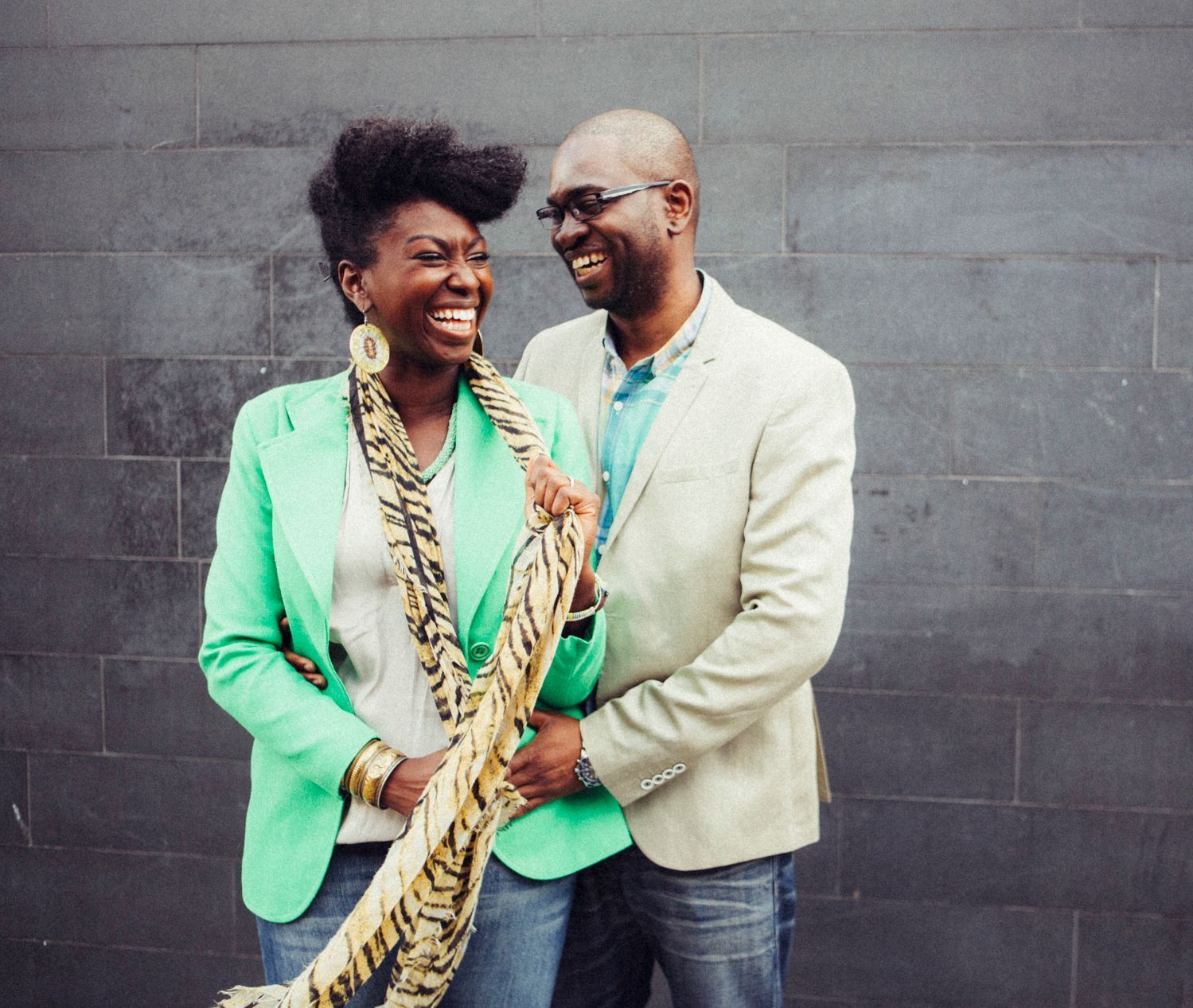 A man and a woman are standing next to each other and smiling