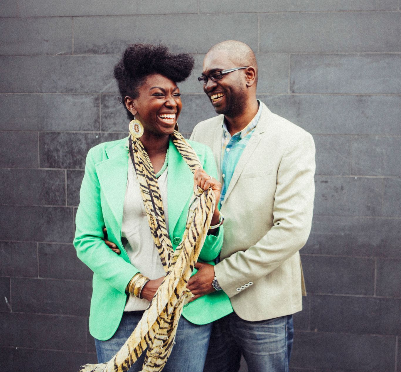 A man and a woman are standing next to each other and smiling