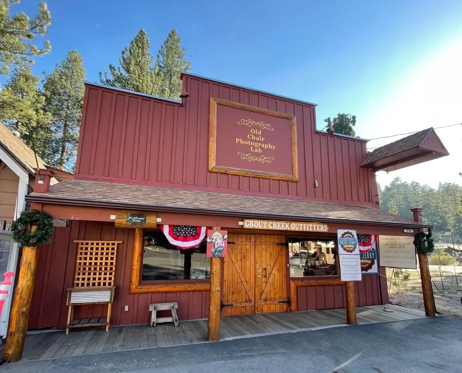 Red wooden building with gold sign,