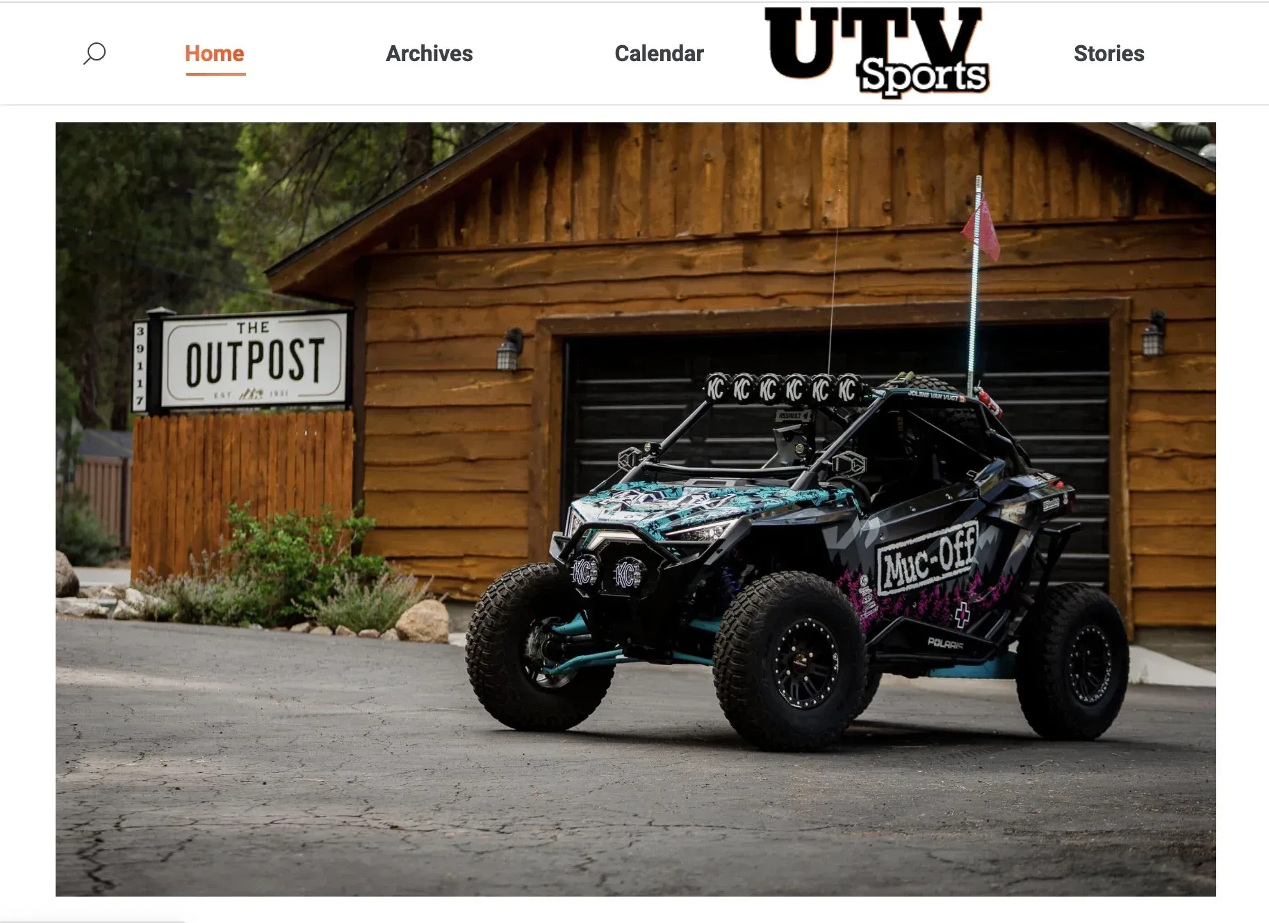 UTV parked in front of a wooden building with an