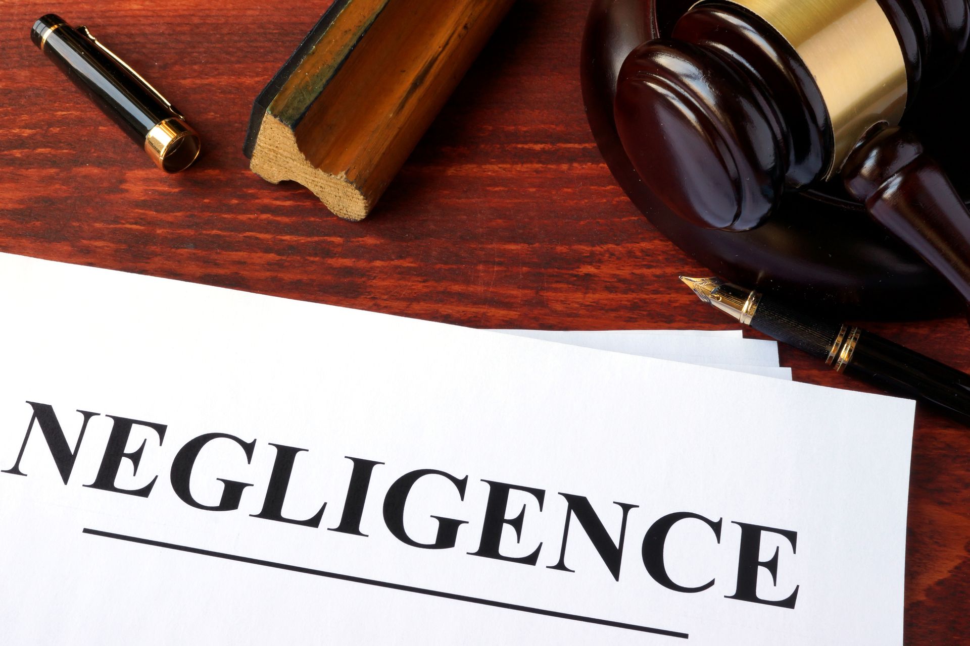 negligence on a table with gavel and other law items