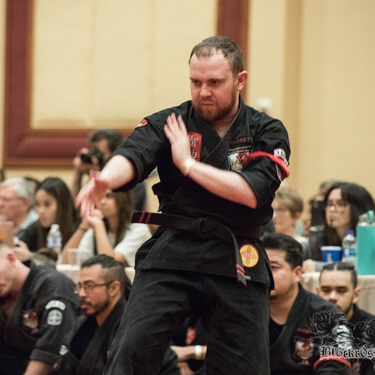 A group of men are practicing karate in a gym.