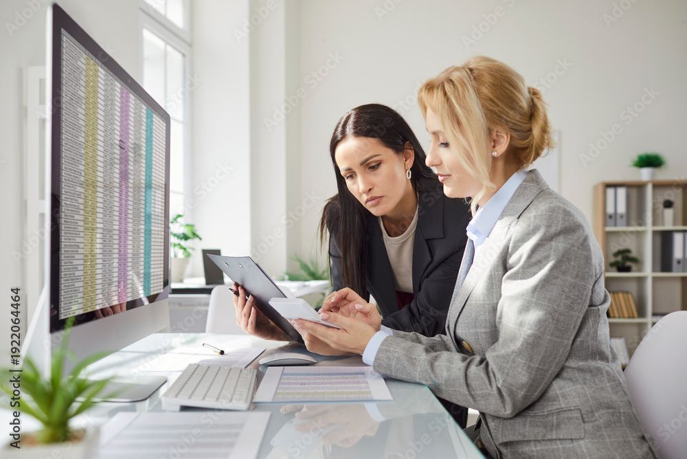 An accountant is showing some numbers to a woman.