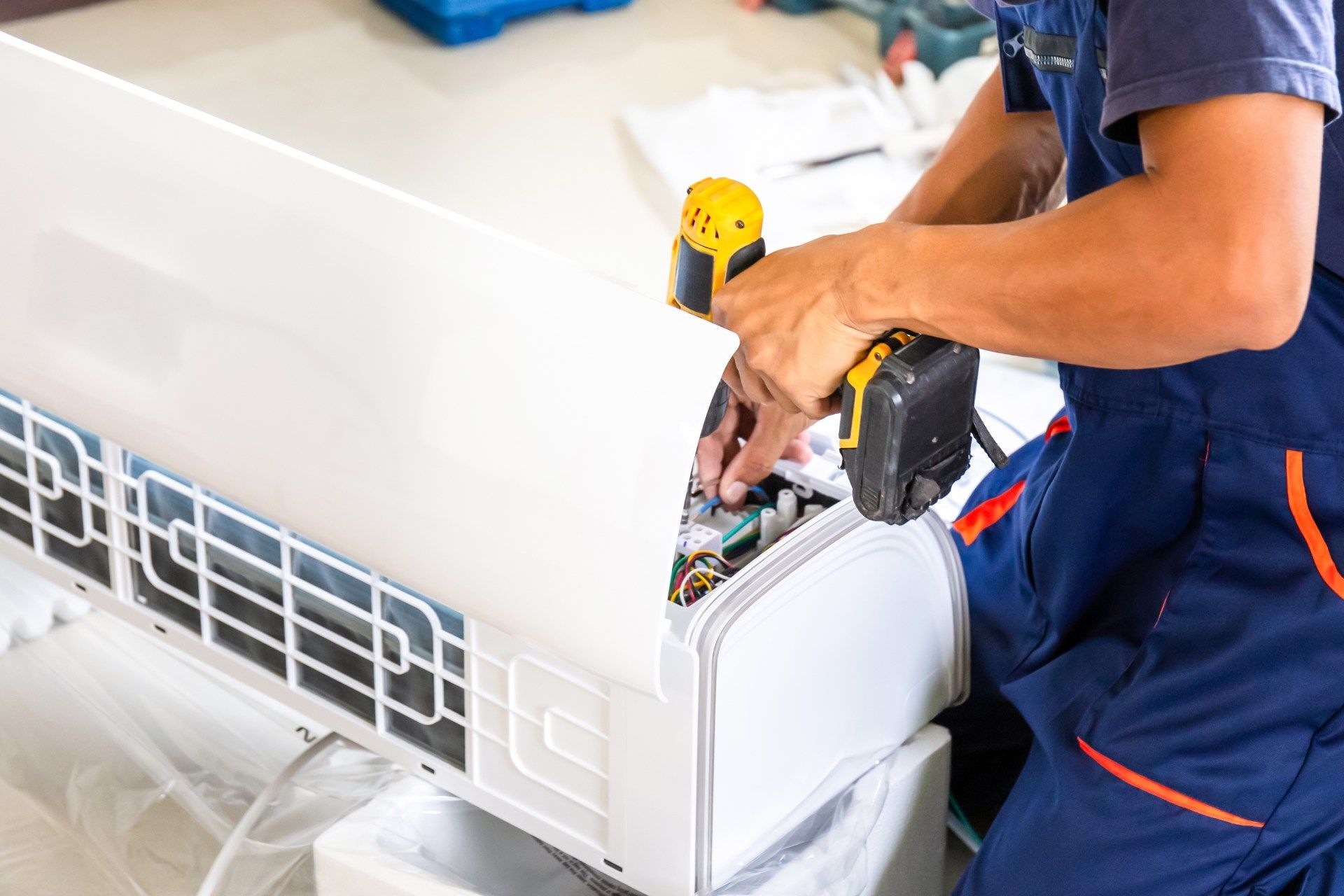 Air conditioning technicians install new air conditioners in homes
