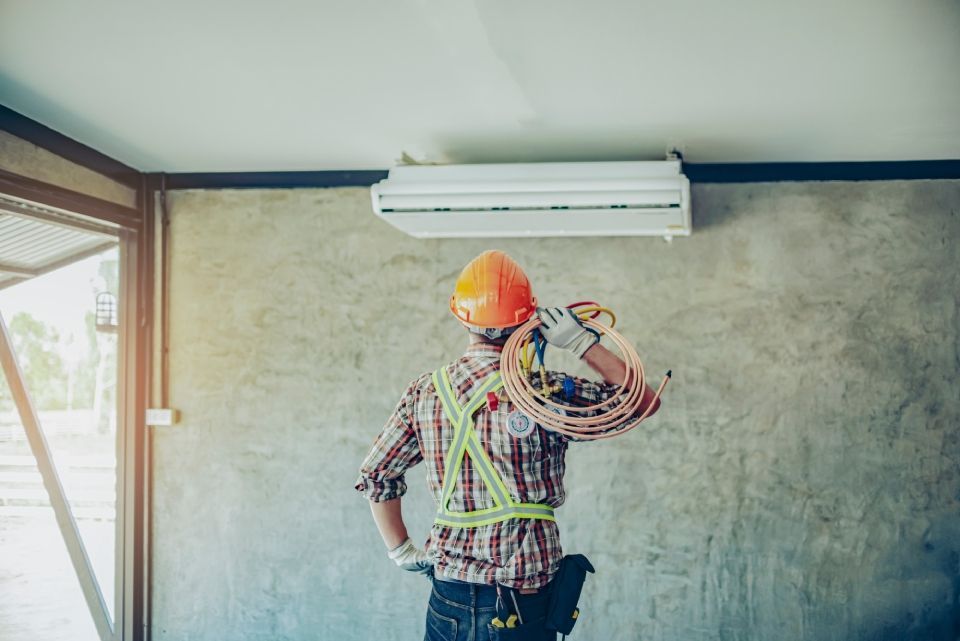 air-conditioning installation technician is about to repair air conditioning in homes and buildings