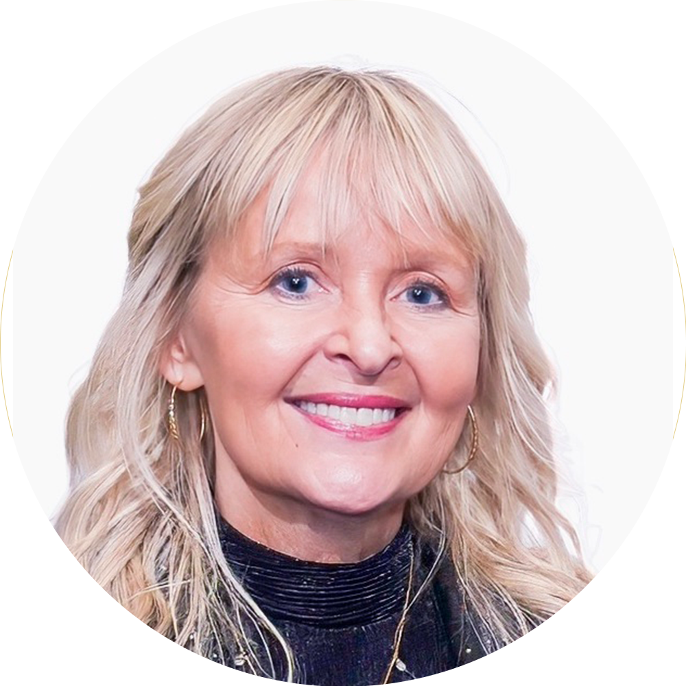 Smiling blonde woman in a black top against a white background