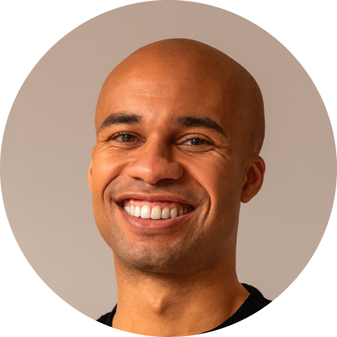 Smiling bald man against a beige background