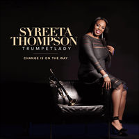 Syreeta Thompson sits on a chair, wearing a dark dress with a trumpet beside her, titled 