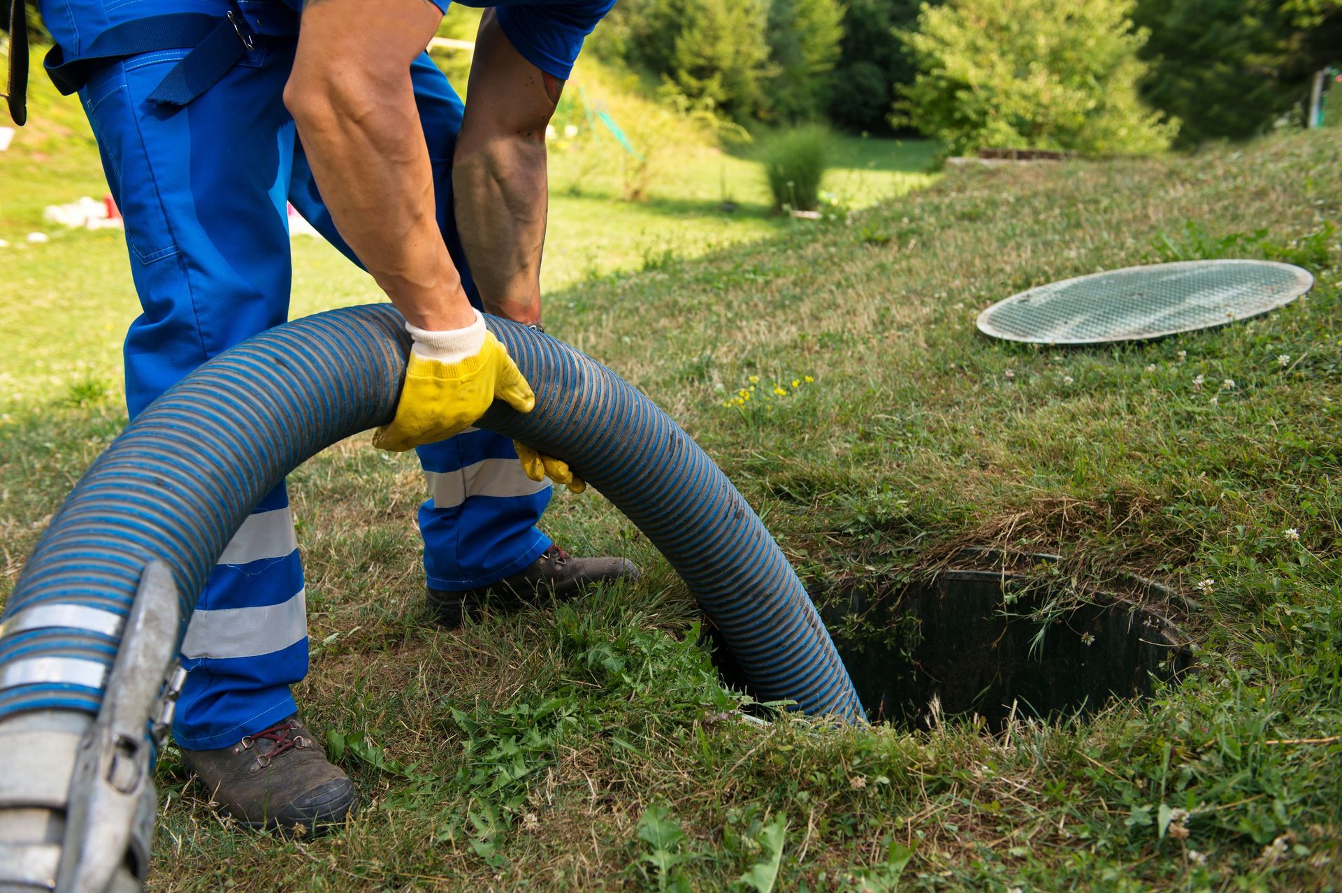 A man is pumping a septic tank.
