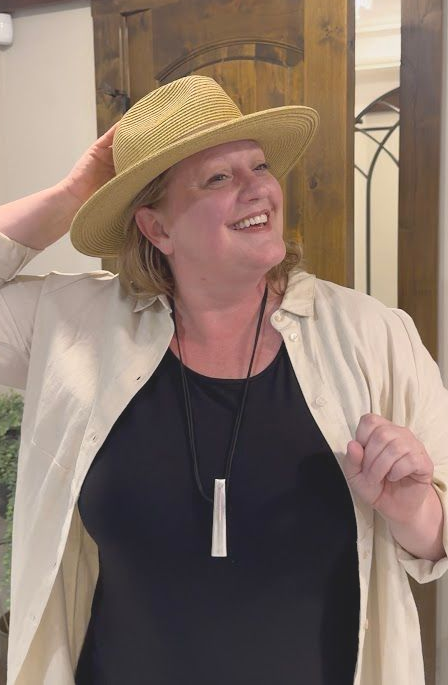 woman trying on a straw hat