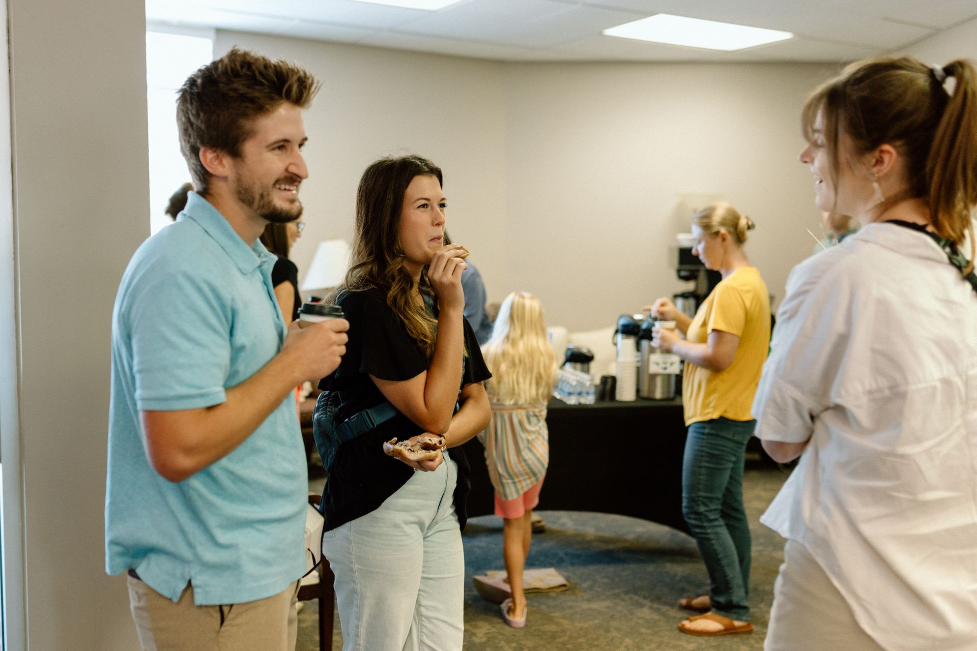 Photo of Athens members chatting in the main lobby before a Sunday worship service.