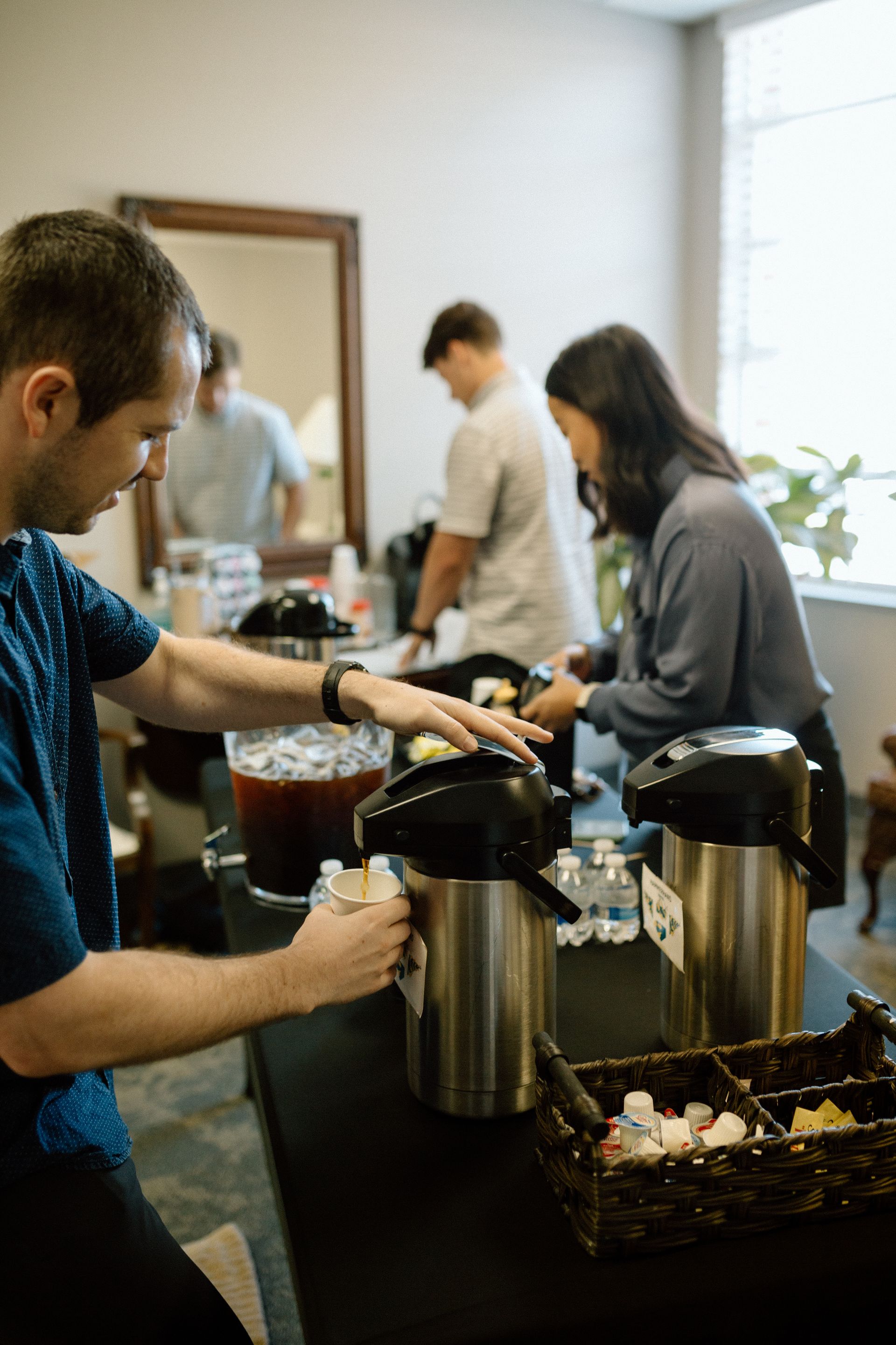 Photo of Athens members getting coffee in our main lobby before a Sunday worship service.