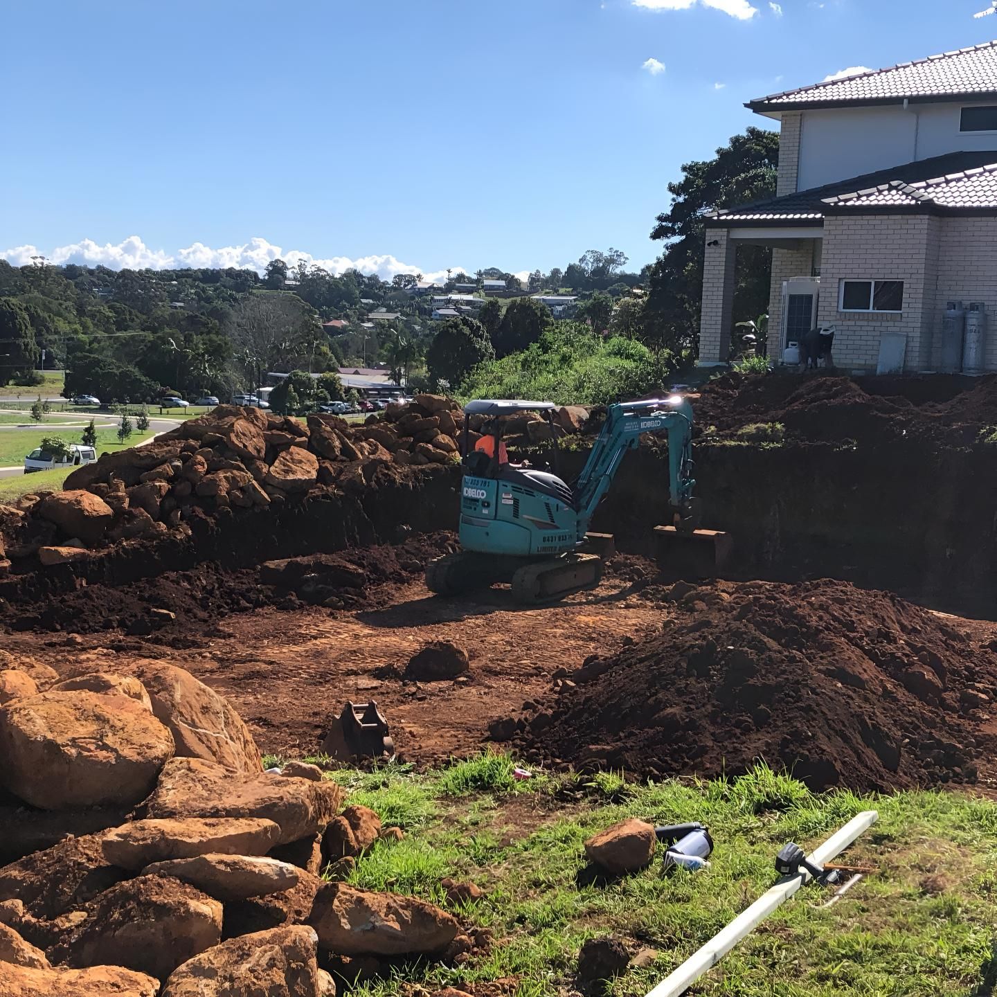 A Large Pile of Dirt is in Front of a House — Limited Access Excavation In Casino, NSW
