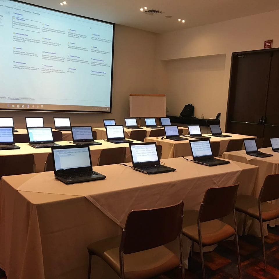 Sala de conferencias con filas de ordenadores portátiles