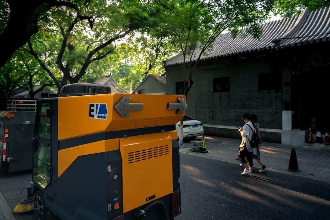 A yellow and black vehicle is parked on the side of the road.