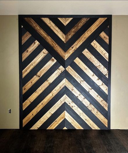 Black and gold chevron wood wall art panel in a room