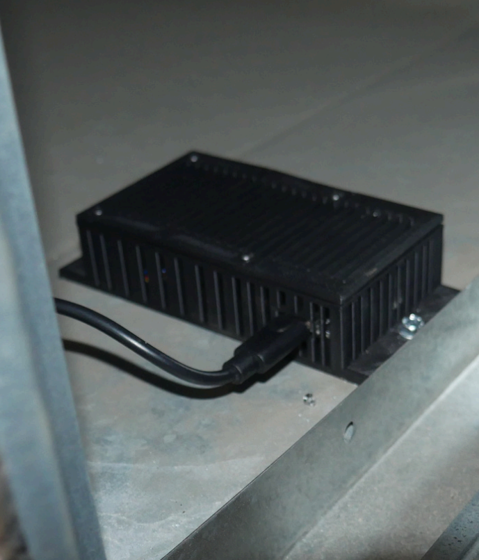 An AirGuard device with a cord plugged into it.