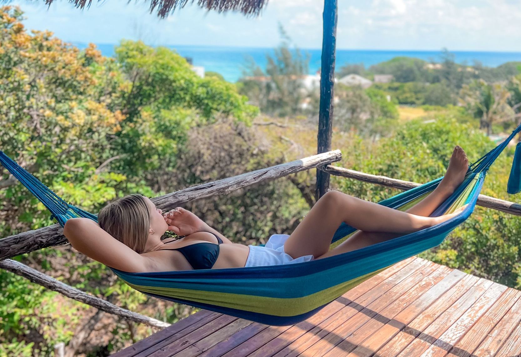girl on a hammock looking at the view of Paradise Dunes