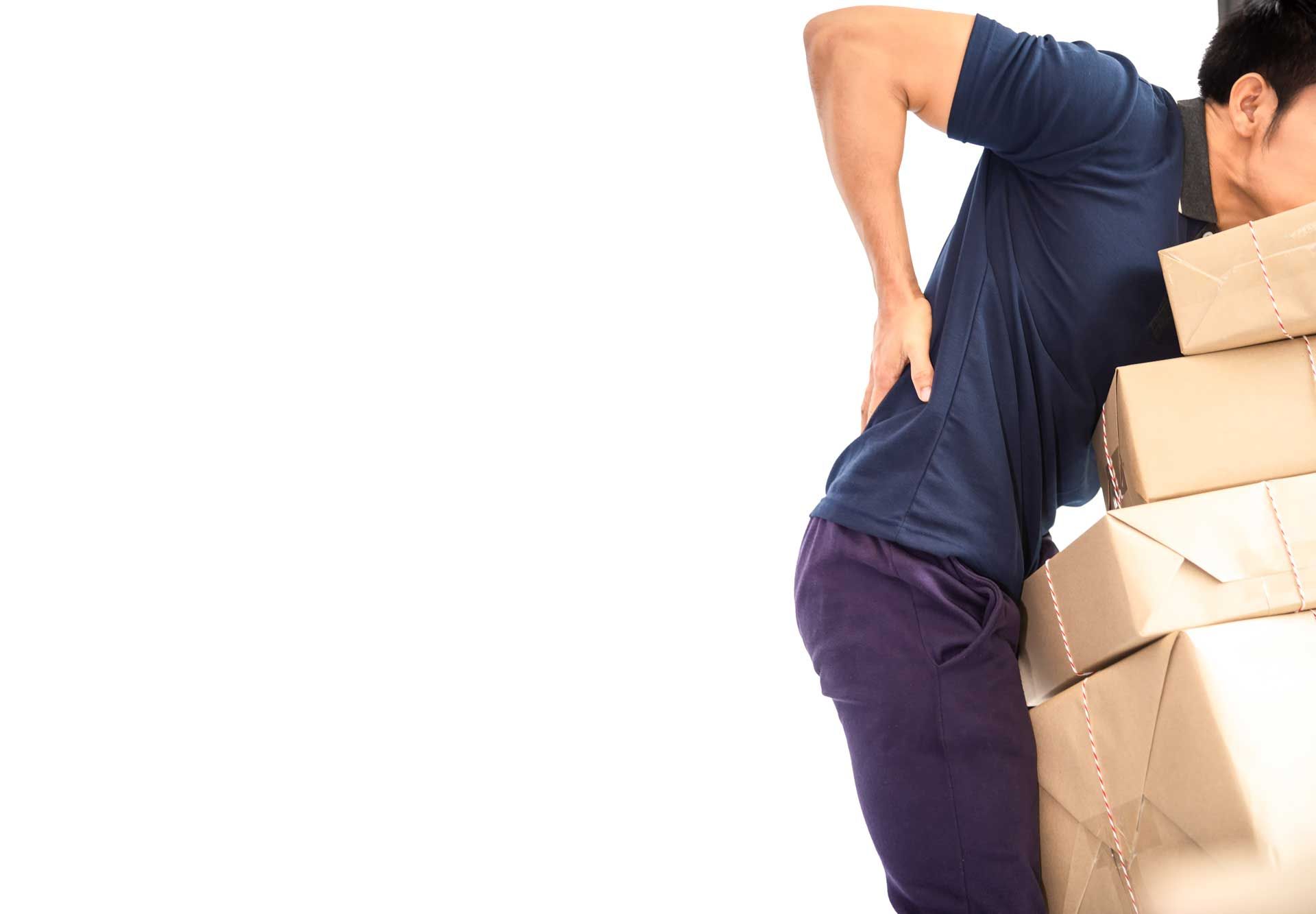 Man with back pain, bent over carrying stack of boxes.