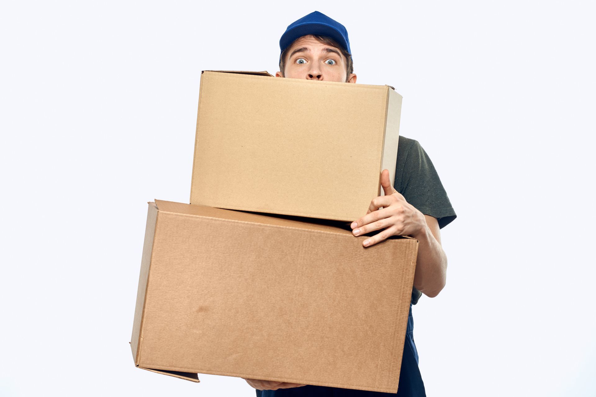 Delivery person holding two cardboard boxes, looking surprised. White background.